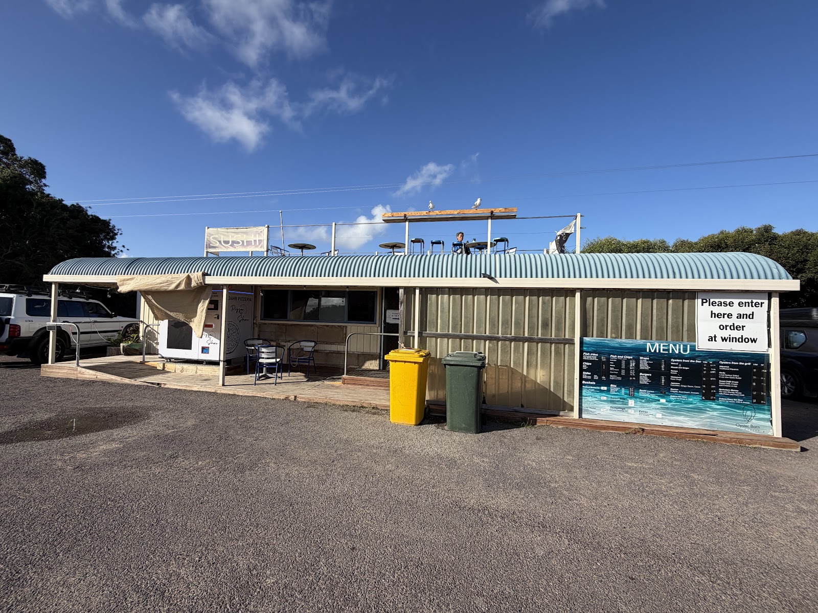 The Oyster Barn in daylight, with the menu board and the rooftop deck above