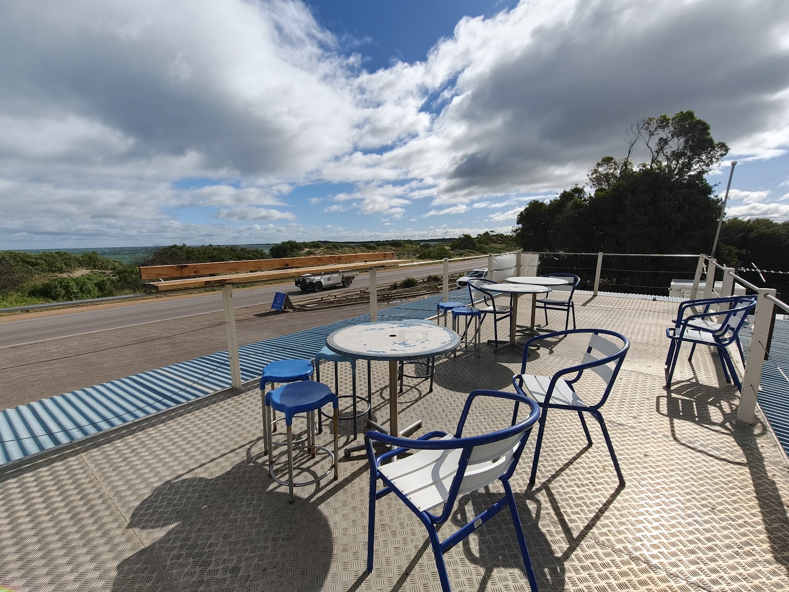 Tables and stools on the Oyster Barn rooftop, looking out over the Eyre Highway